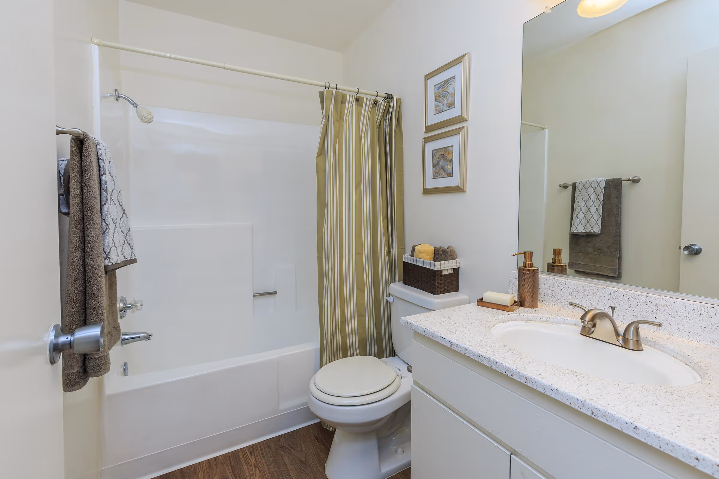 Bathroom with white cabinets, vanity and shower tub combo with curtain