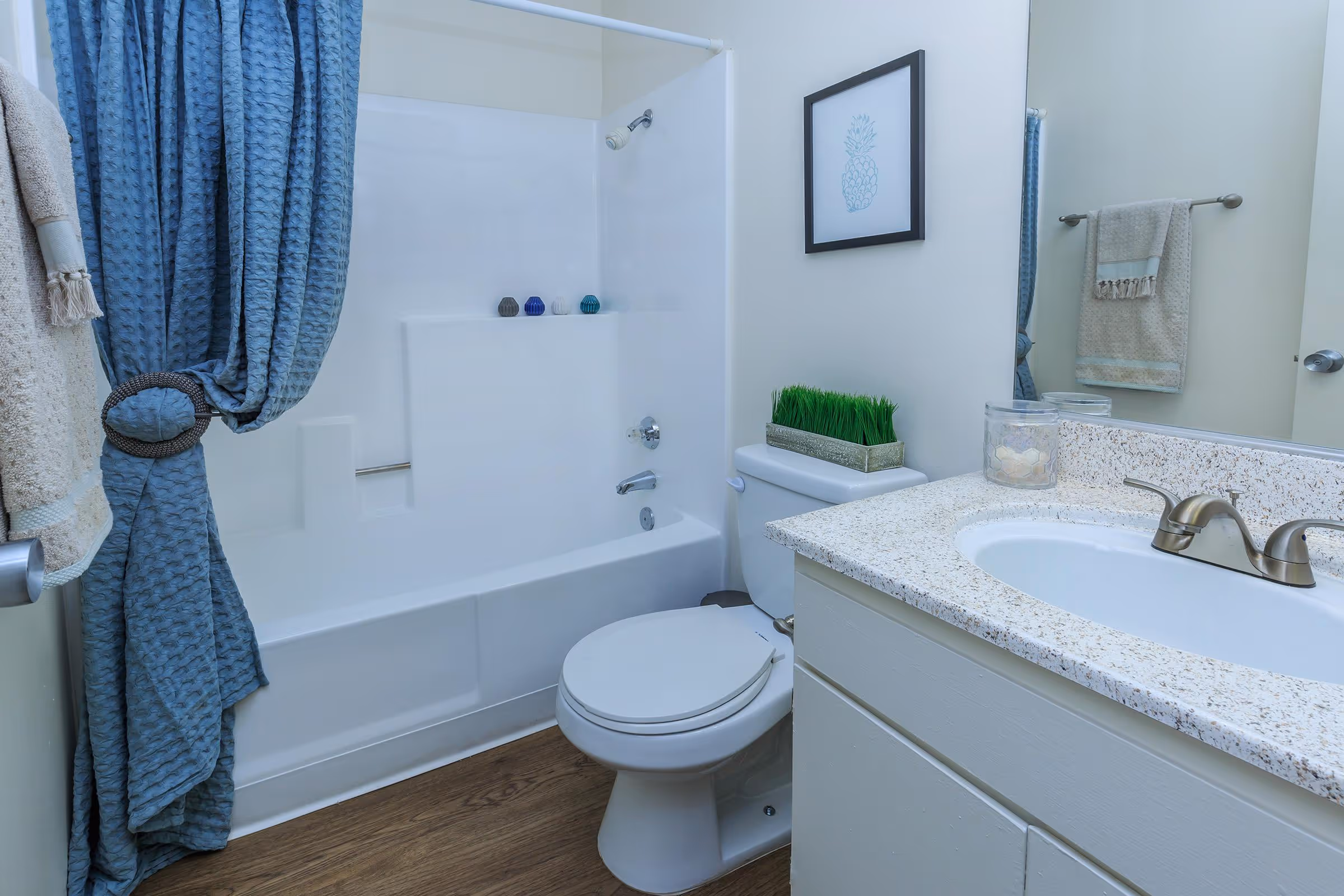 Bathroom with white cabinets, vanity and shower tub combo with curtain