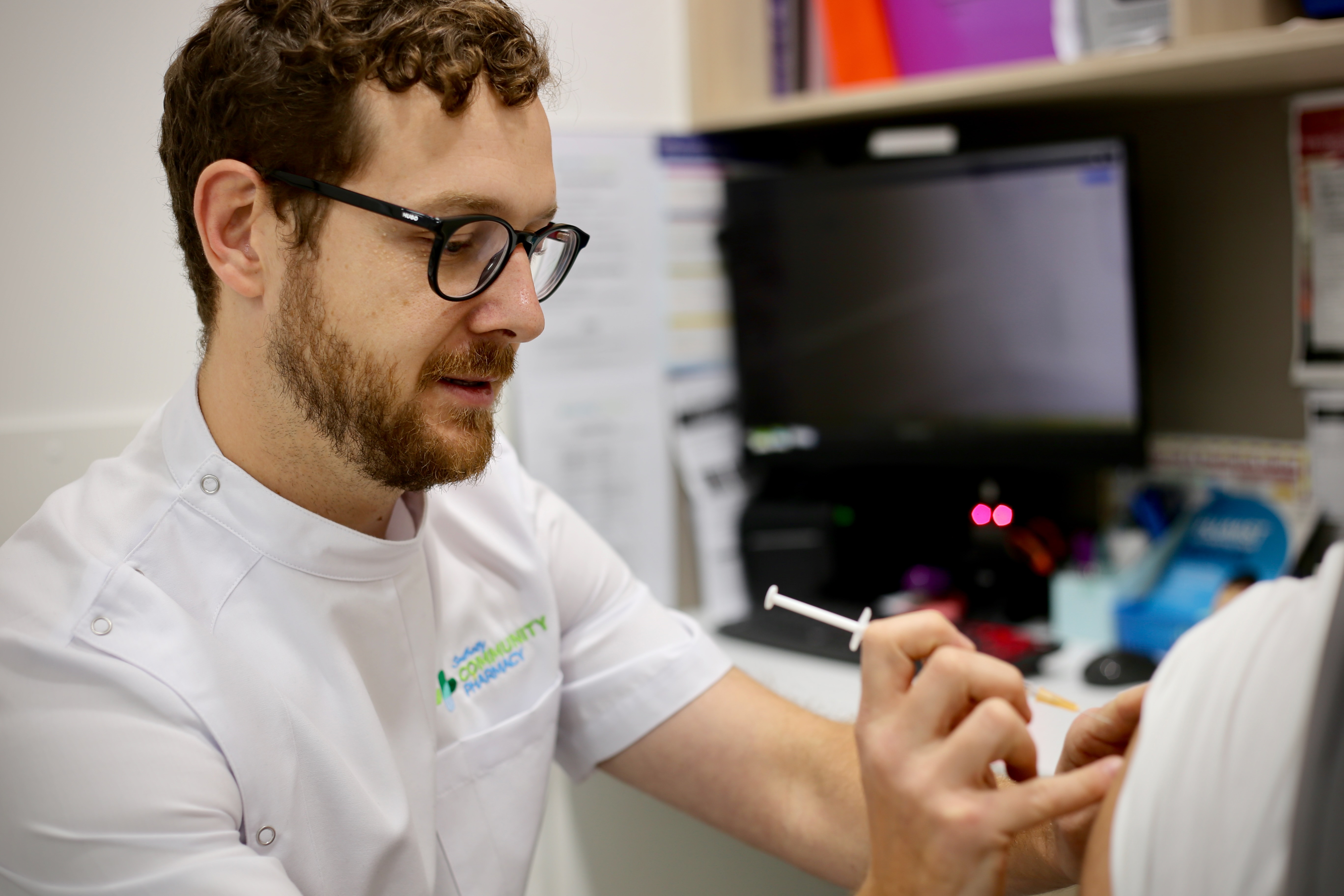 Southcity Community Pharmacy pharmacist Darko preparing a vaccination for a patient