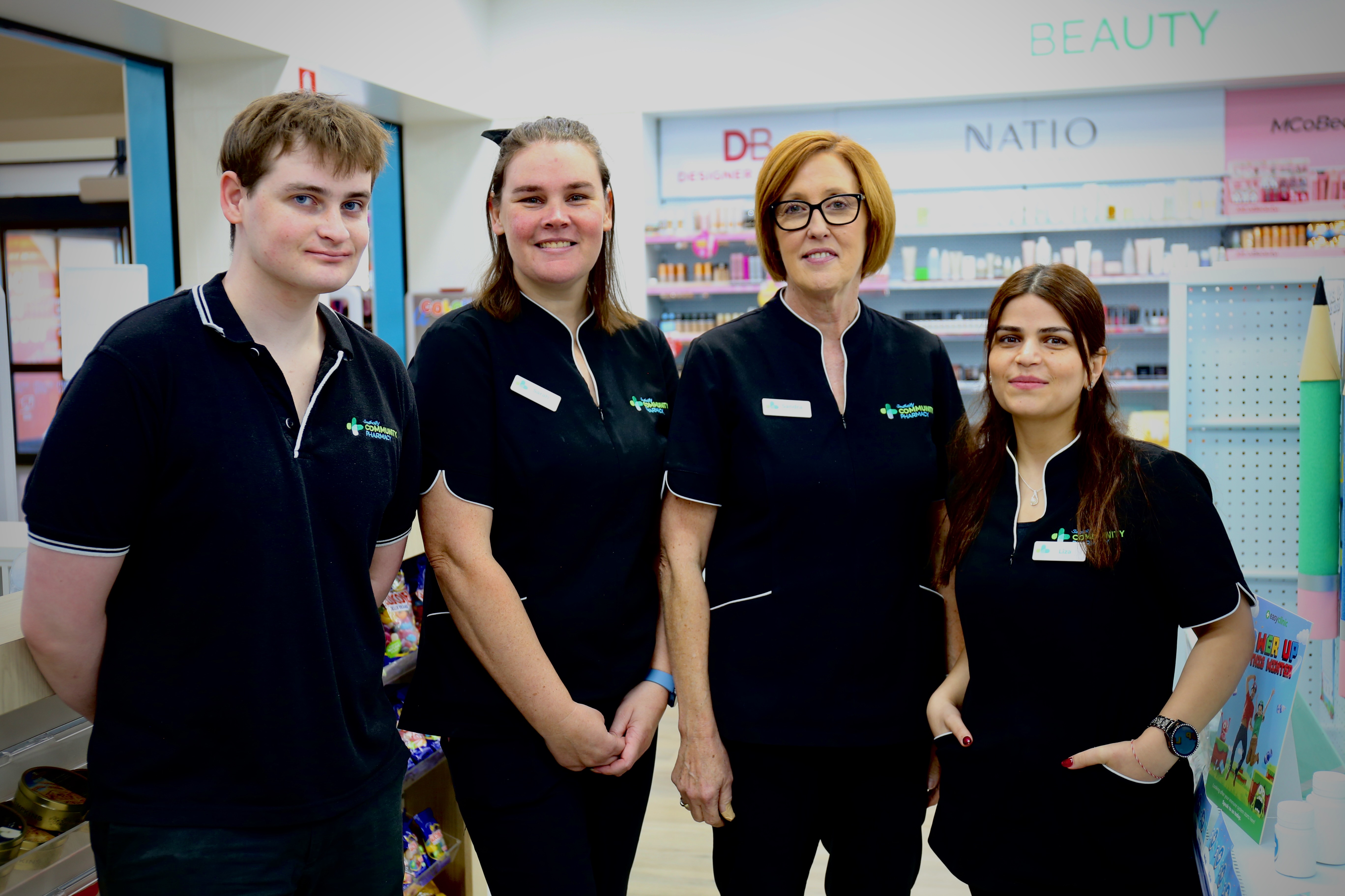 Southcity Community Pharmacy assistants team standing together in store, ready to help customers