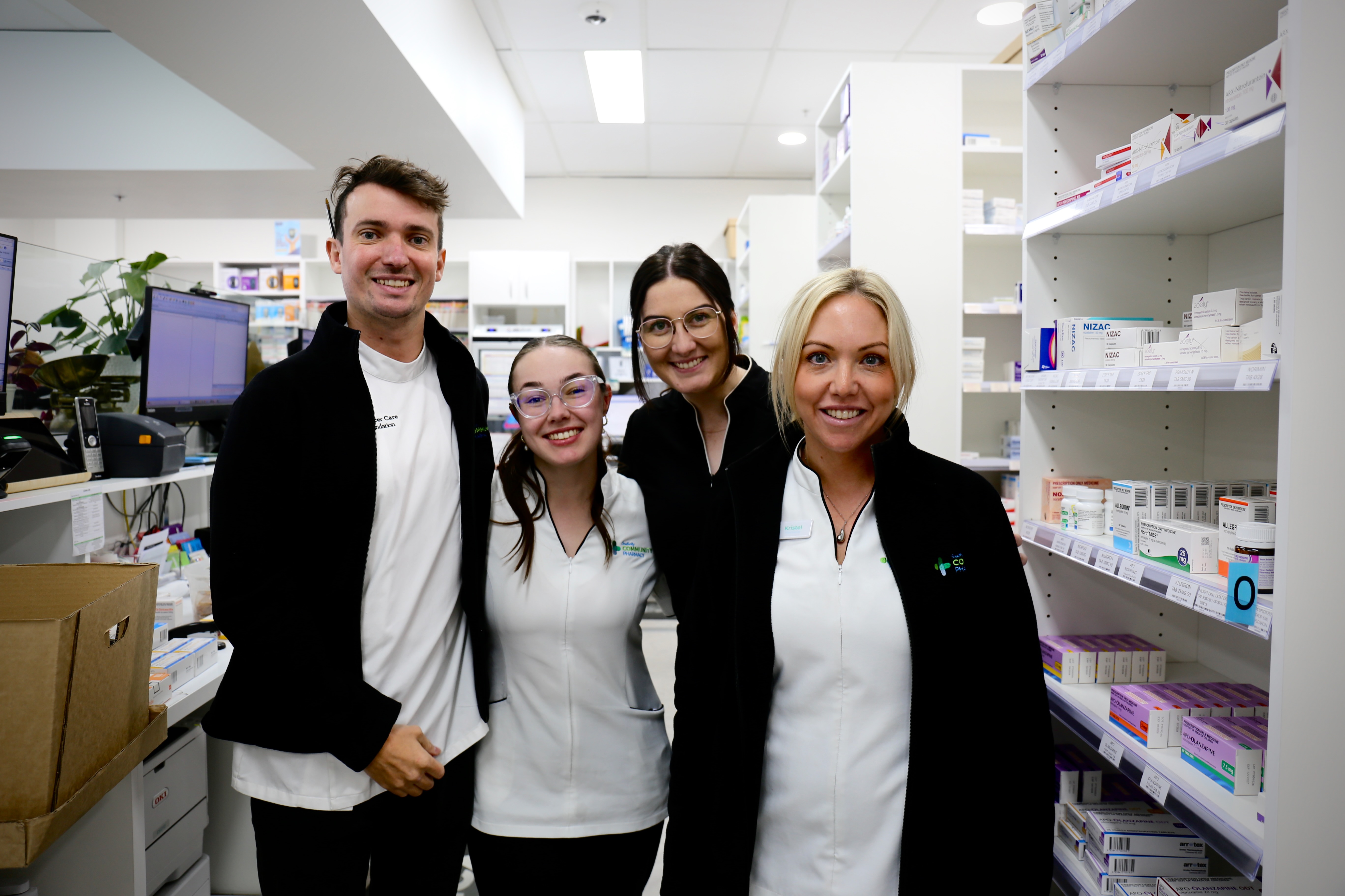 Southcity Community Pharmacy retail team members standing together in store