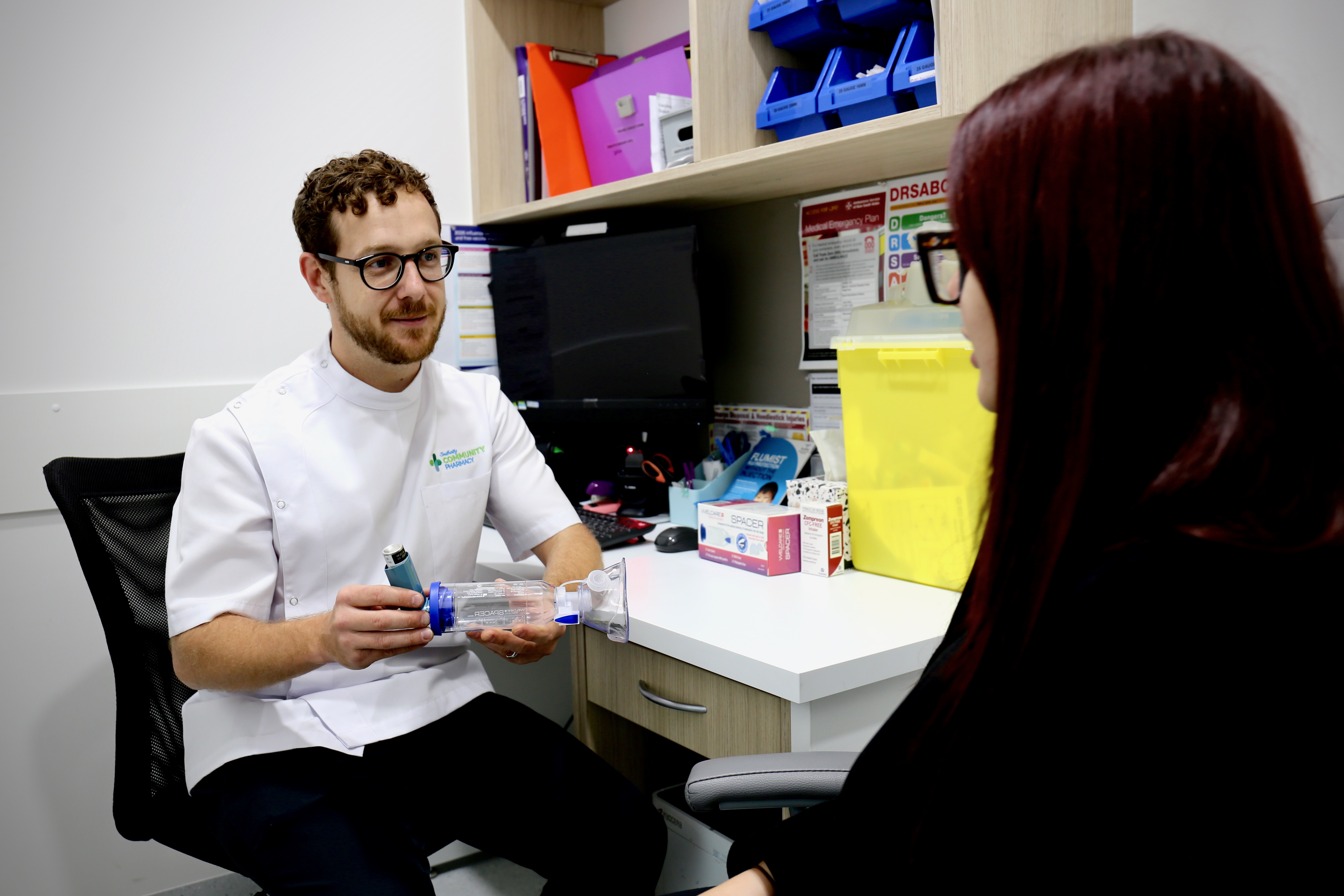 Pharmacist Darko demonstrating inhaler and spacer use to a patient during a consultation at Southcity Community Pharmacy