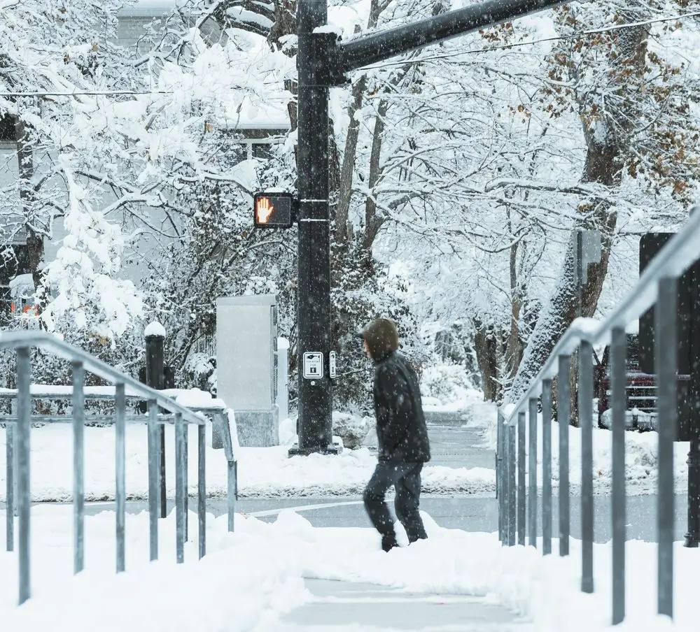 man walking through icy road in kitsilano