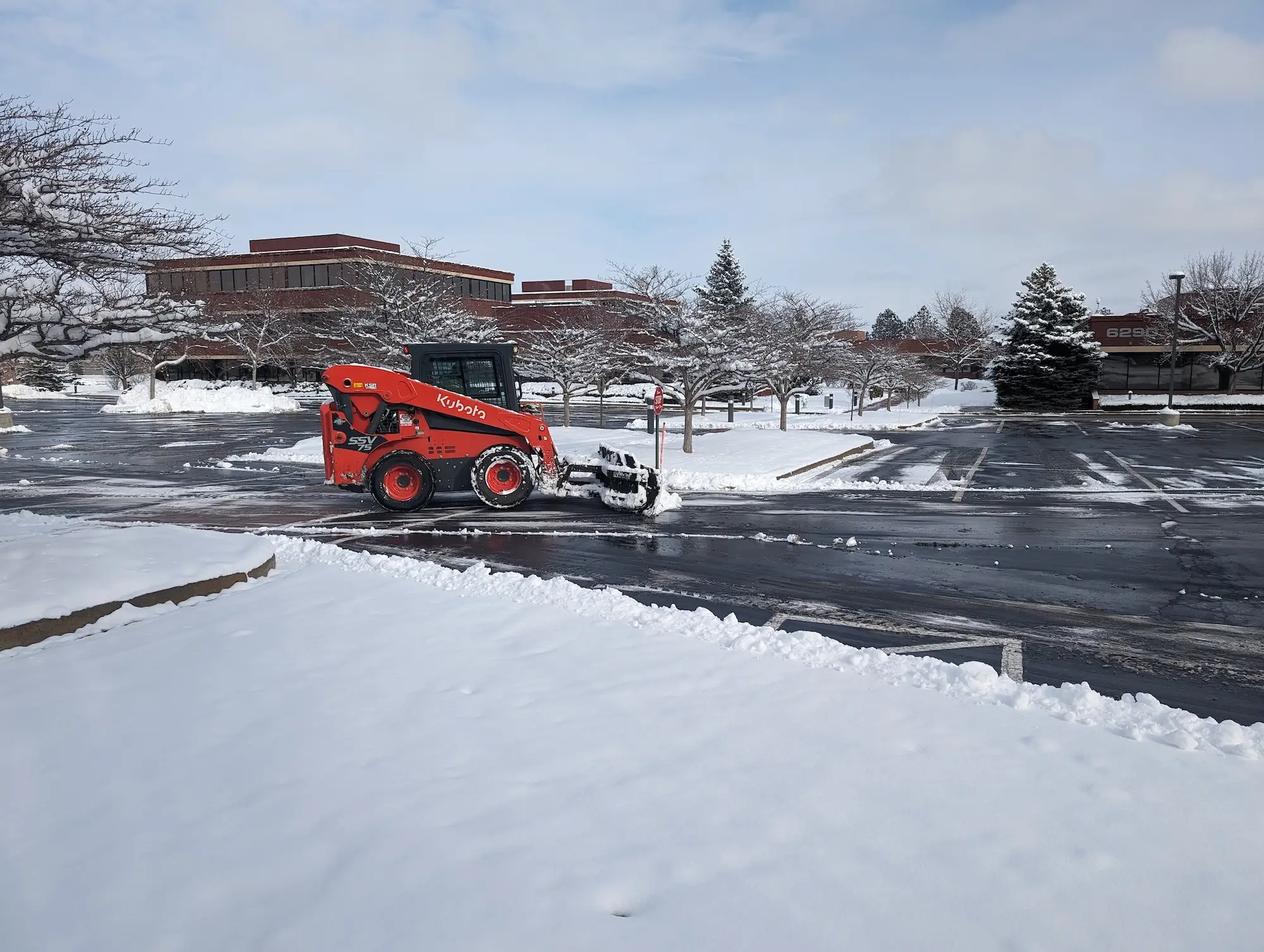 Bobcat performing snow clearing services
