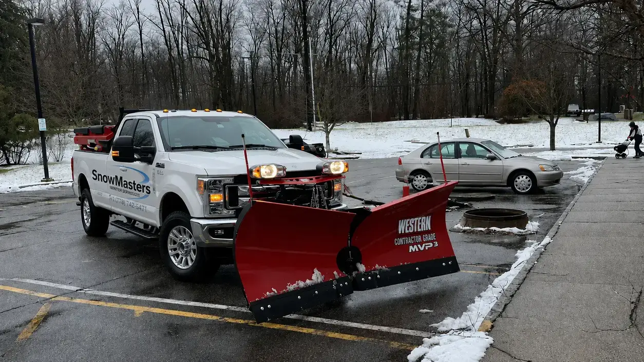 snowmasters winter services truck performing snow plowing services