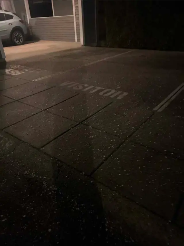 De-icing material applied to visitor parking at a strata property in North Burnaby