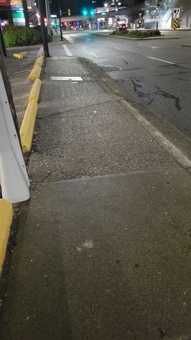 De-icing material applied to a commercial sidewalk near Burquitlam Station in Coquitlam