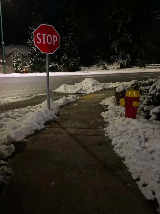 Cleared and de-iced pedestrian sidewalk after snowfall in Westwood Plateau, Coquitlam