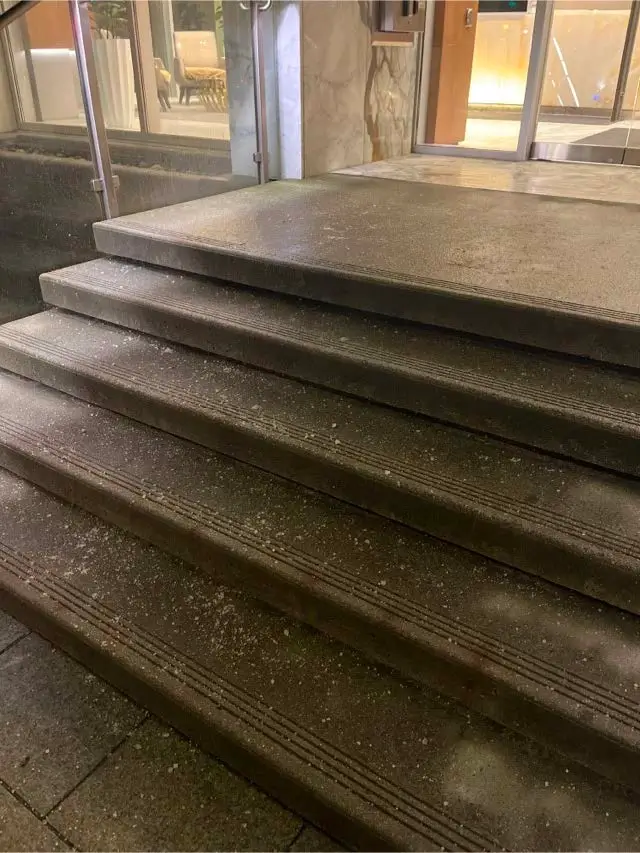 De-icing material applied to exterior entrance steps at a property in Richmond City Centre