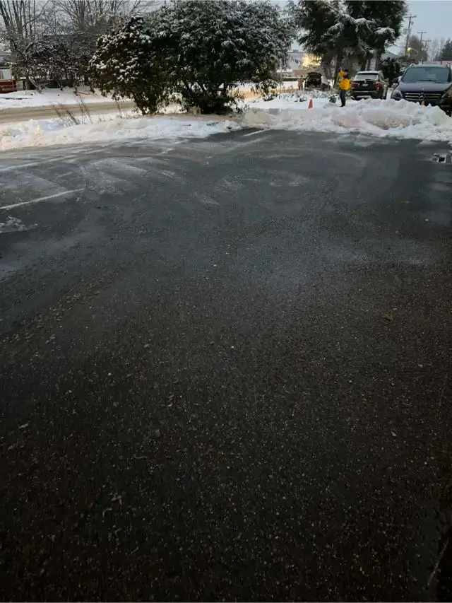 De-icing material applied to parking lot at a commercial property in Richmond, BC