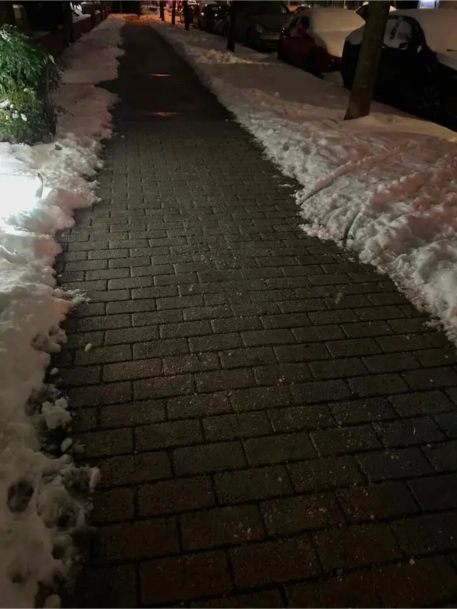 Cleared and de-iced pedestrian walkway after snowfall at a strata property in West Richmond