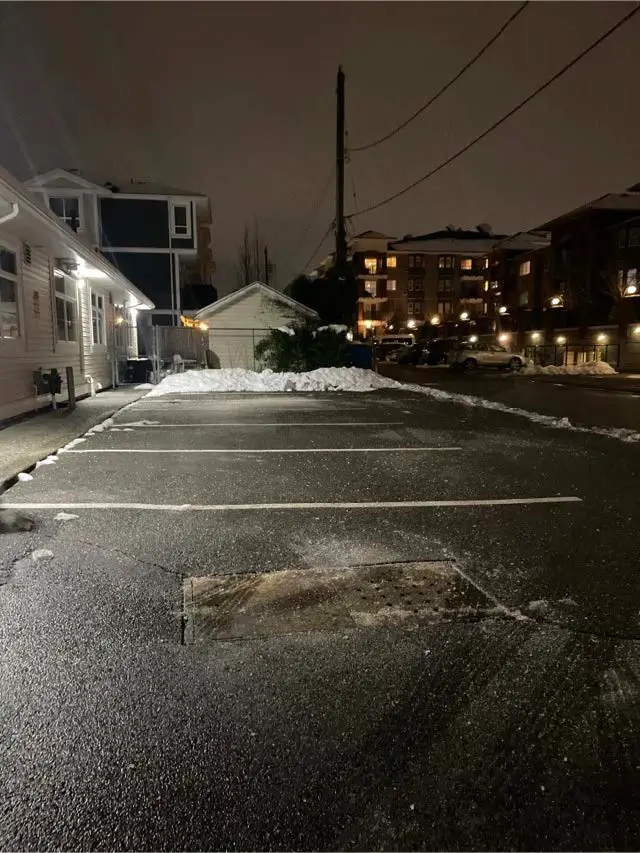 De-icing material applied to a commercial parking area in Surrey.
