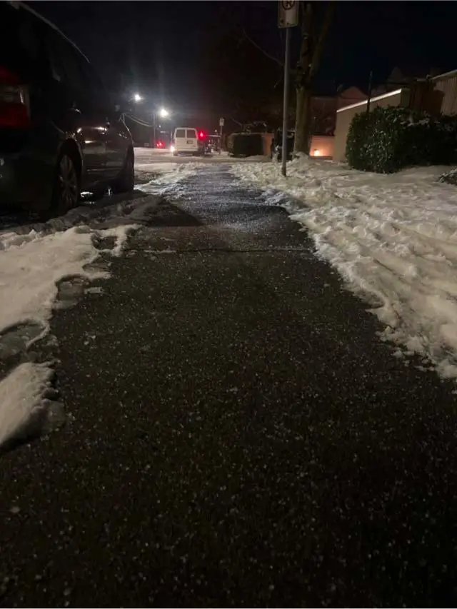 Cleared sidewalk at a Guildford strata townhouse complex after snow removal and de-icing.