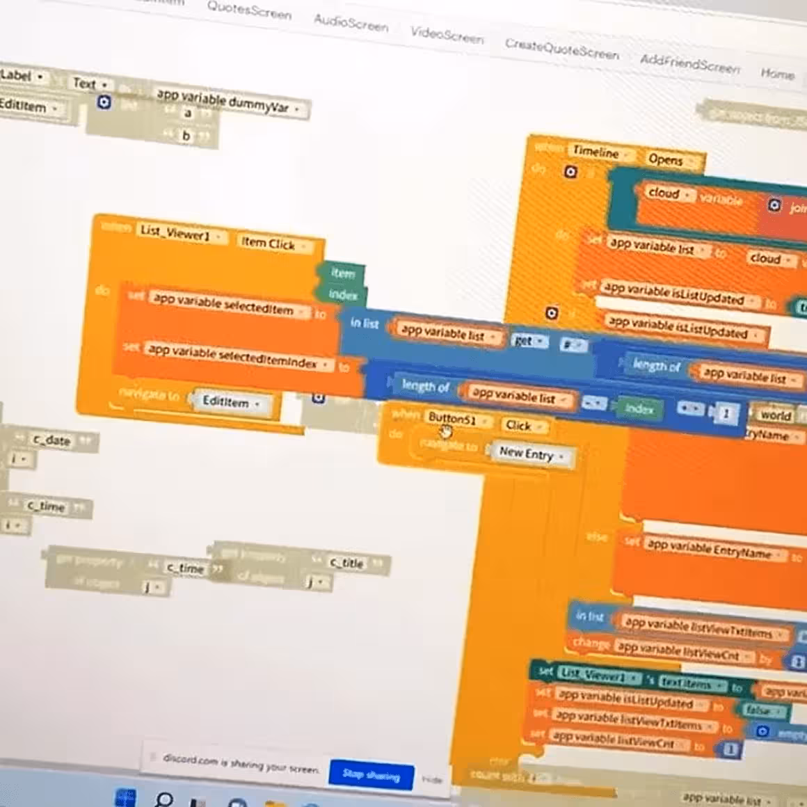 A computer screen showing colorful block-based programming code in a visual coding interface.