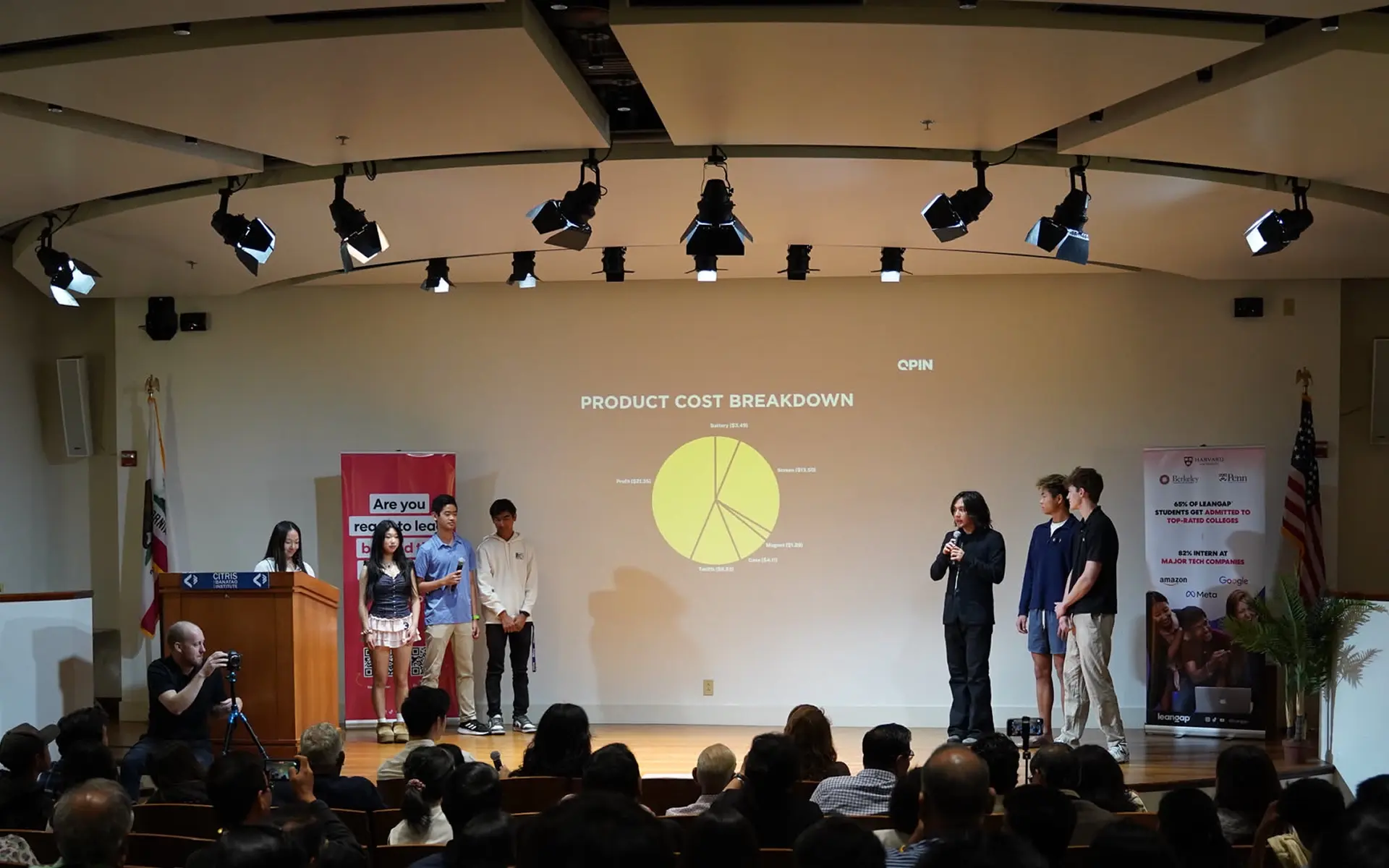 Young founders pitching their startup QPin on stage to a panel of judges at Leangap Demo Day