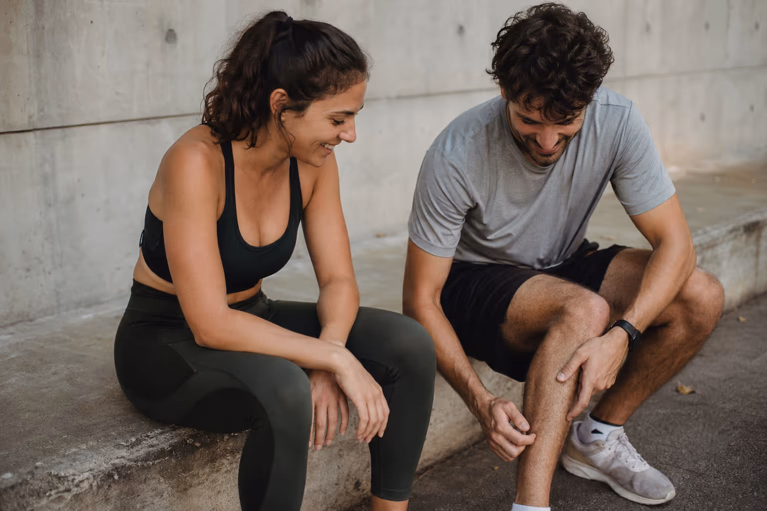 Two people taking a rest together after exercising in an urban setting