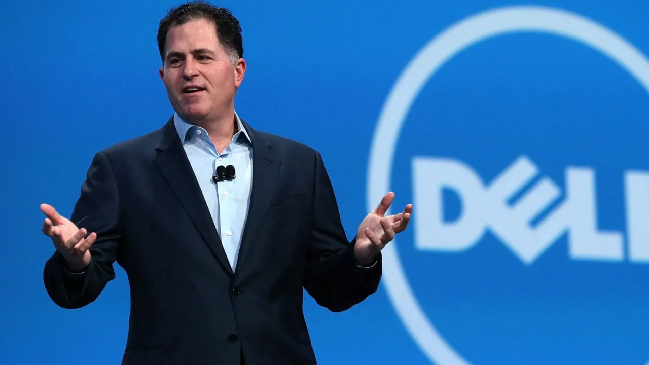 Michael Dell, founder of Dell giving a speech with Dell logo in the background.