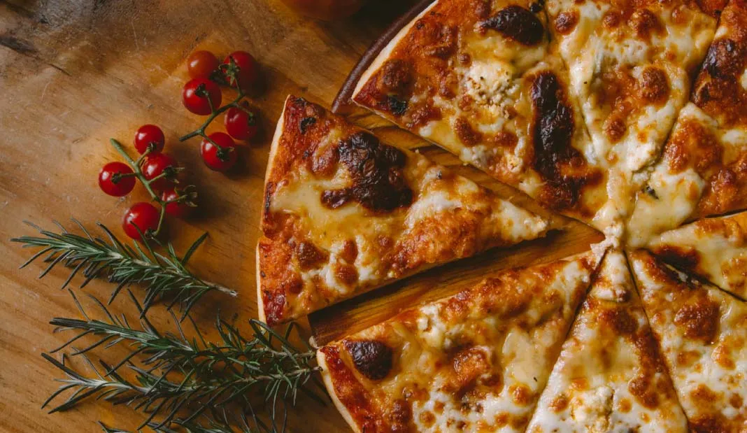 Margherita pizza with a slice cut.