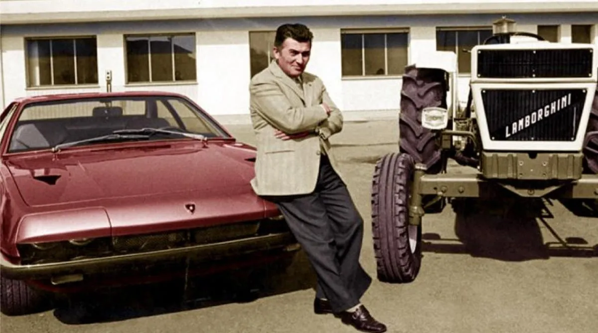 Ferruccio Lamborghini sitting on a Ferrari car next to one of the first Lamborghini tractors.