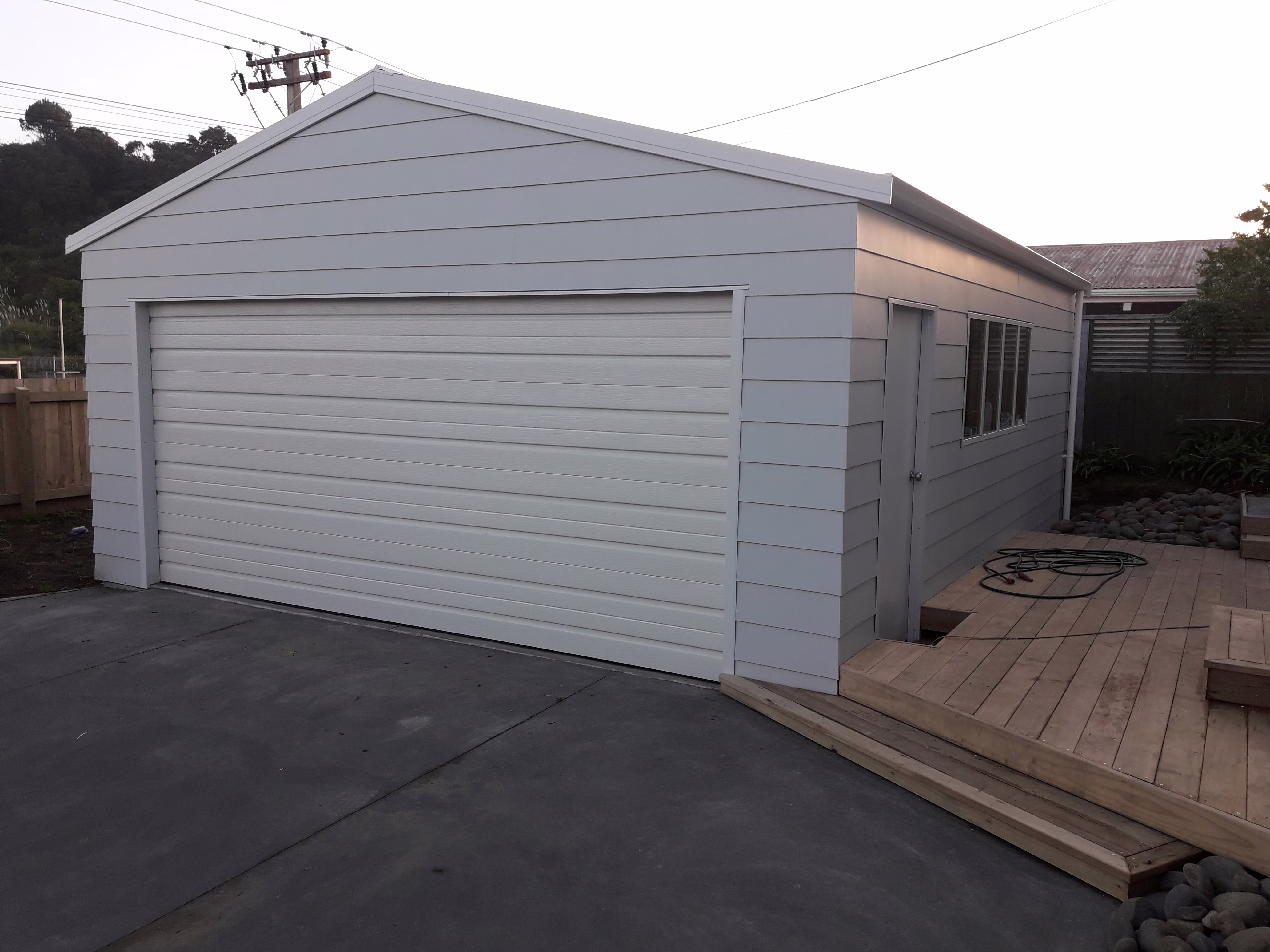 Single bay garage with horizontal cladding installed by Bay Construction