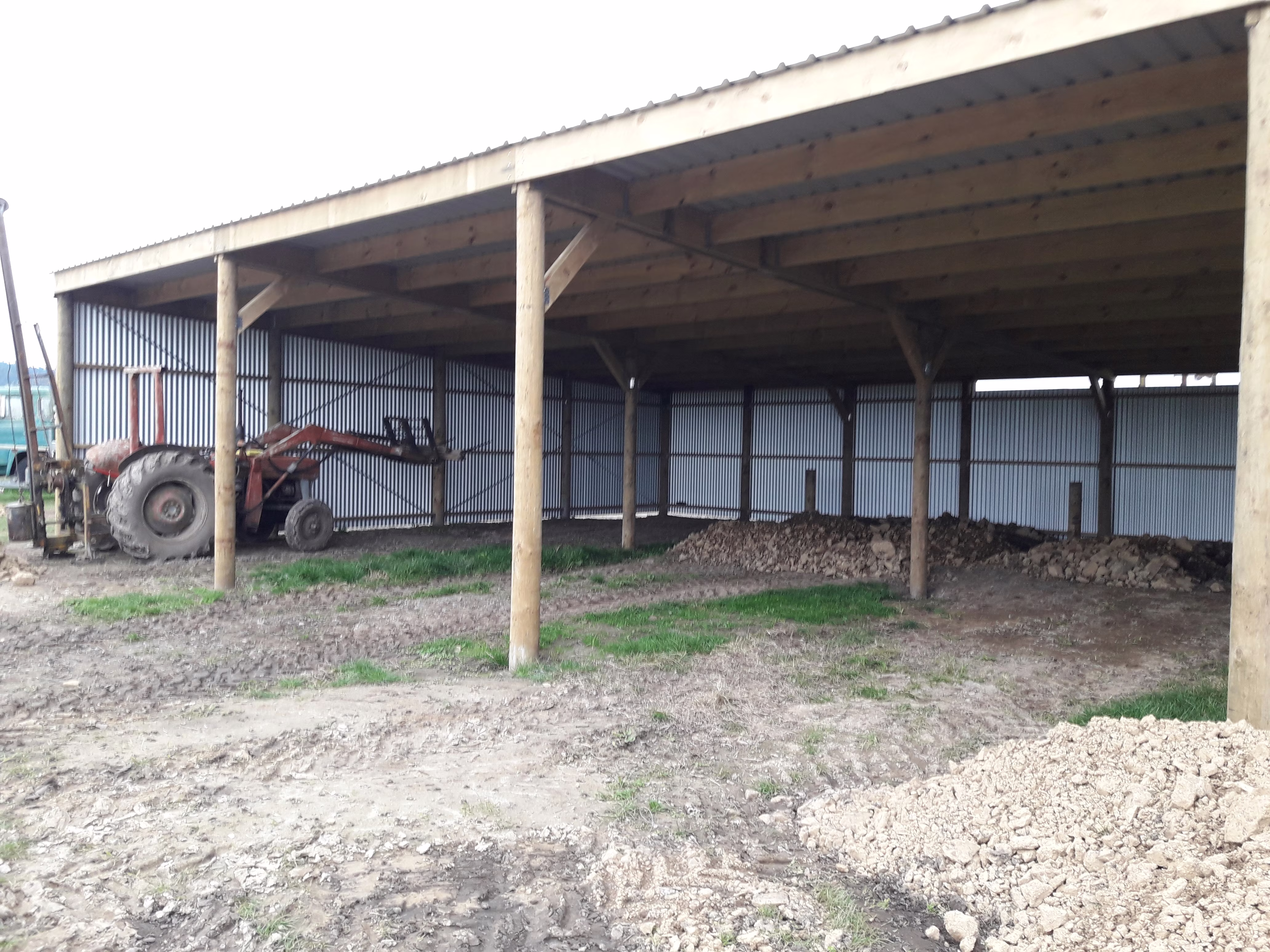 Pole shed interior with open bay tractor storage on an Eastern Bay farm