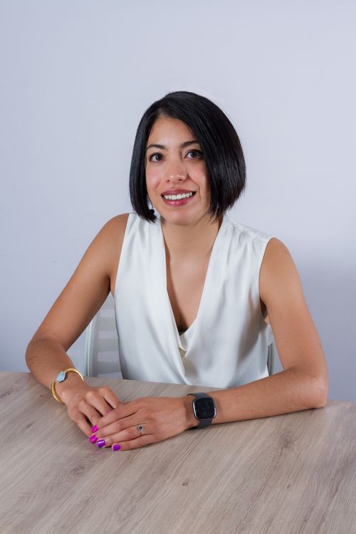 Picture of Mariana Salazar sitting in a table looking professional