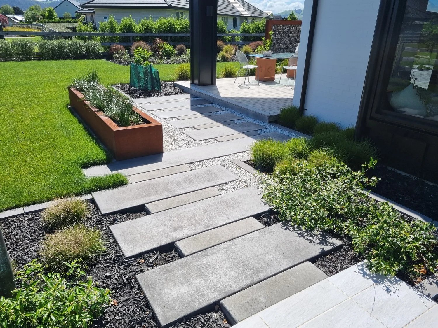 stone pathway, raised planter beds and ornamental garden, residential landscaping Waikato