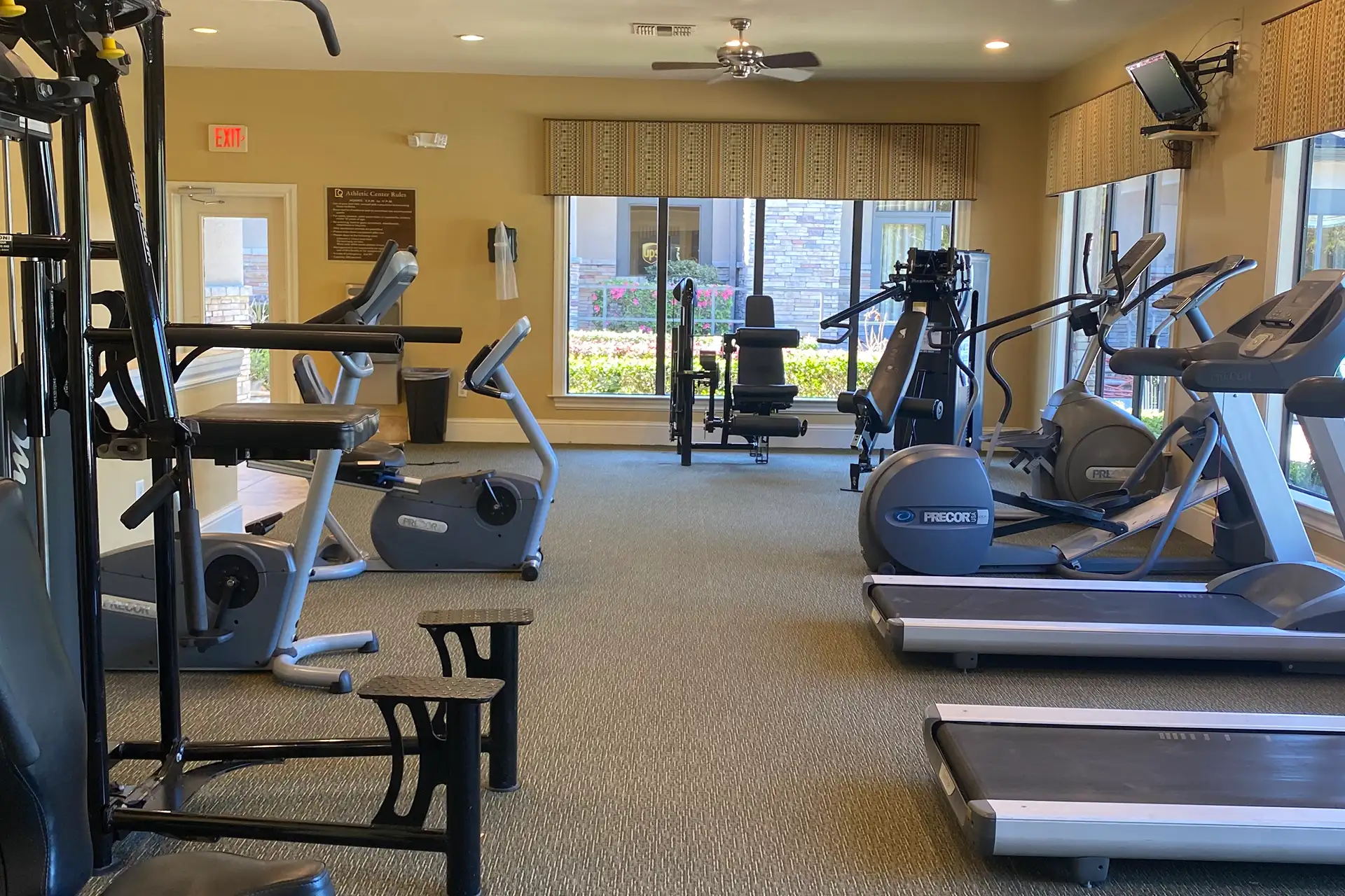 Fitness center with cardio and strength equipment at The Quarters Apartment Homes