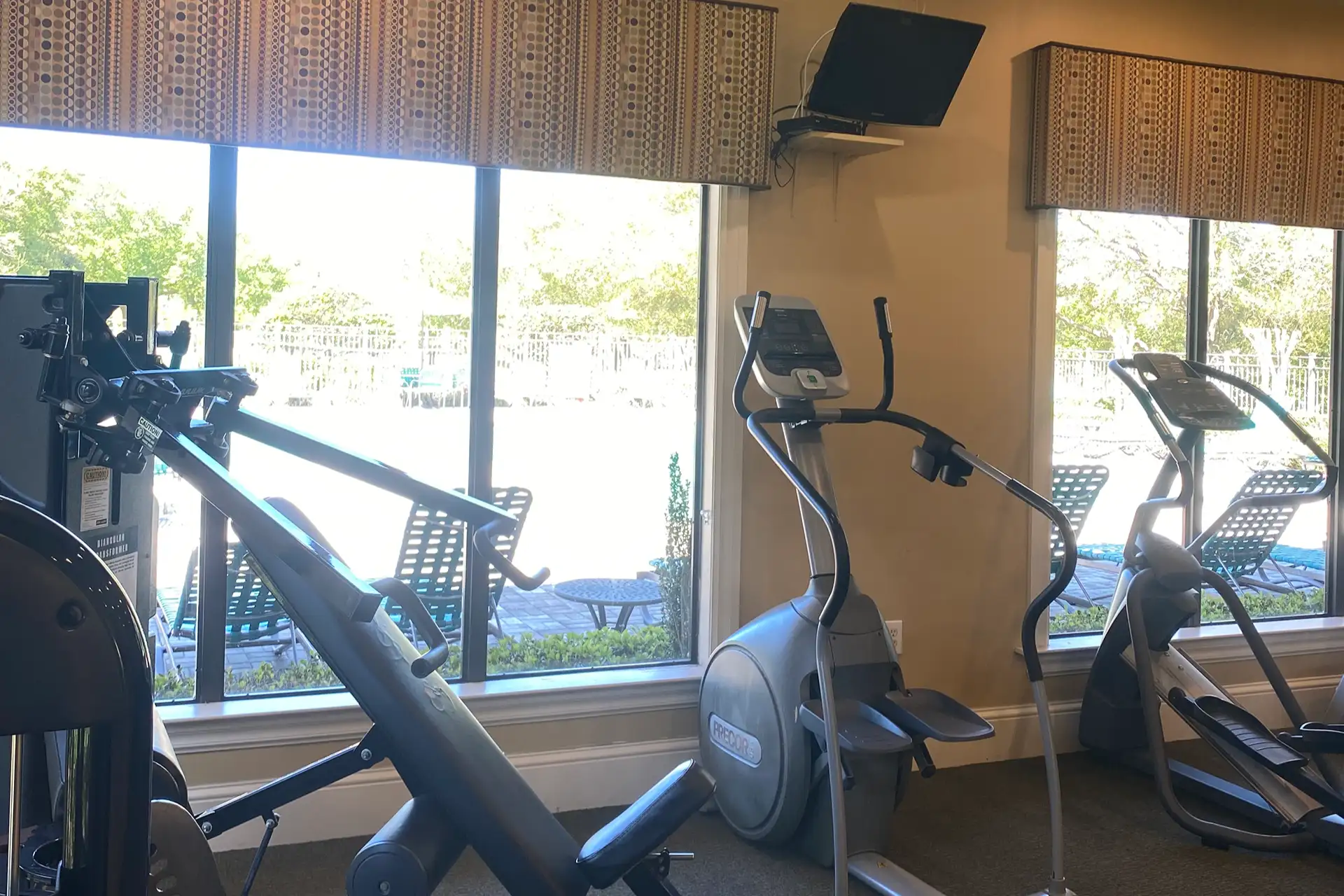 Fitness center with cardio and strength equipment at The Quarters Apartment Homes