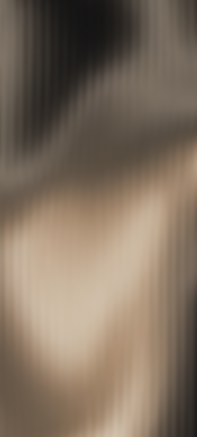 Close-up of a smooth, light-colored surface with soft shadows.