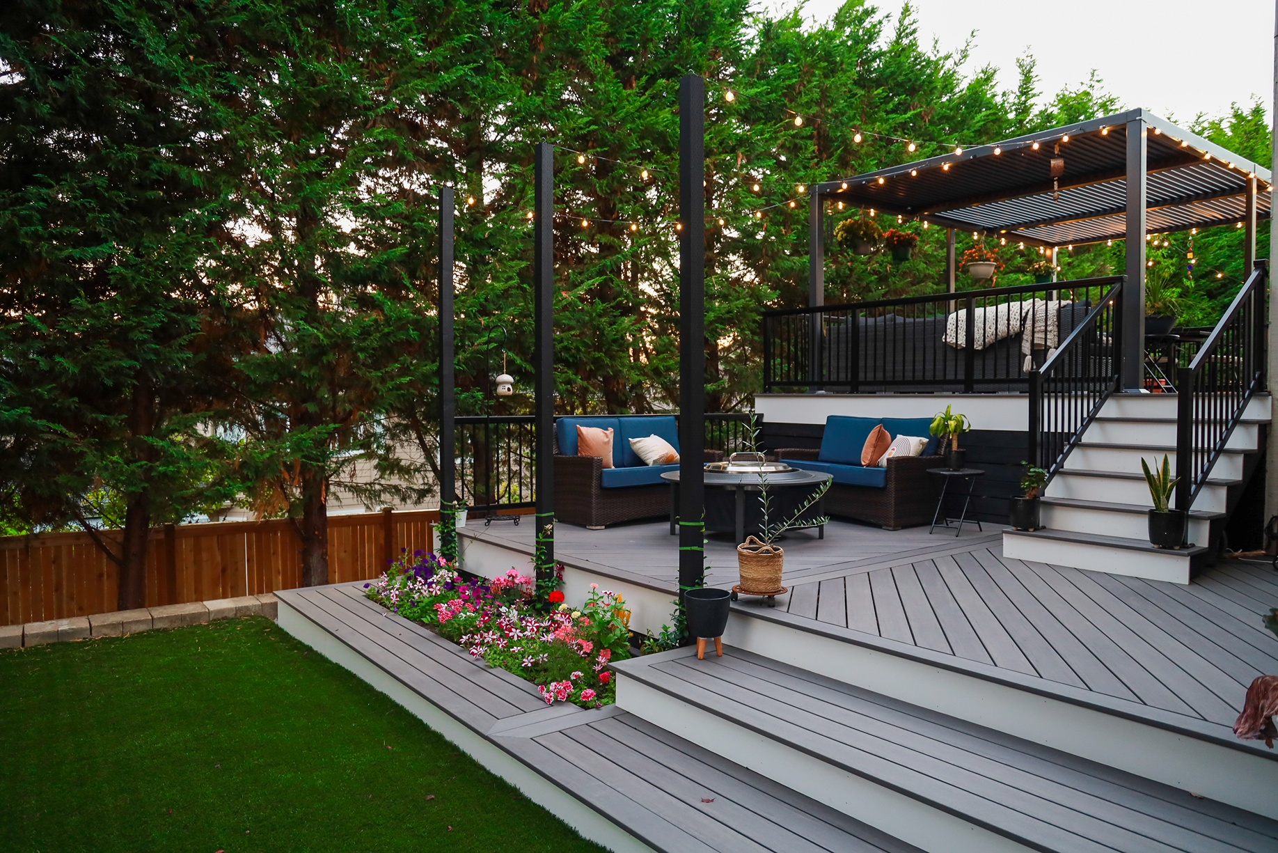 A newly transformed backyard with an installed deck and sofa set for outdoor activities