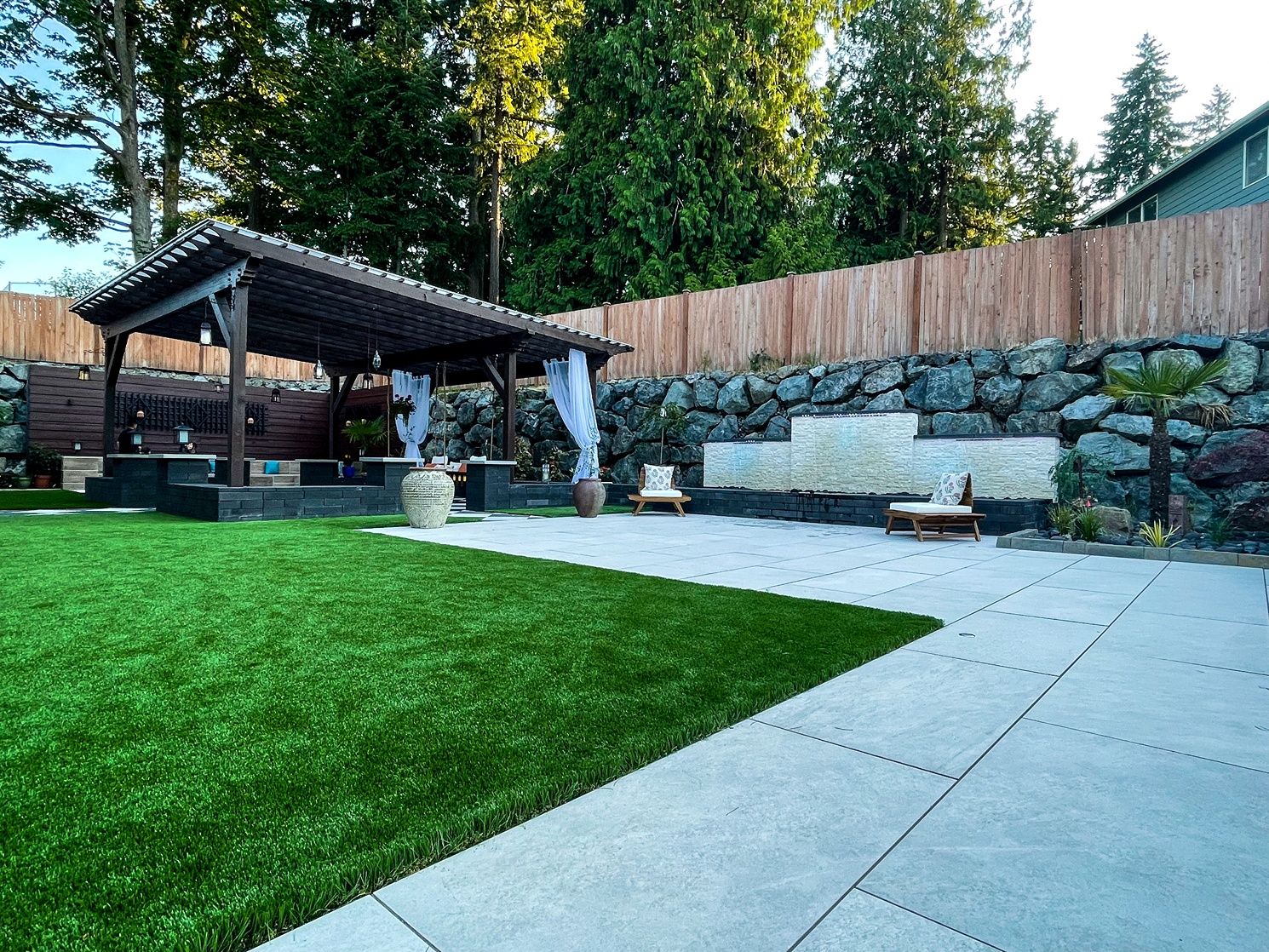 An exterior of a Seattle property with an open lounge area designed by a landscape contractor