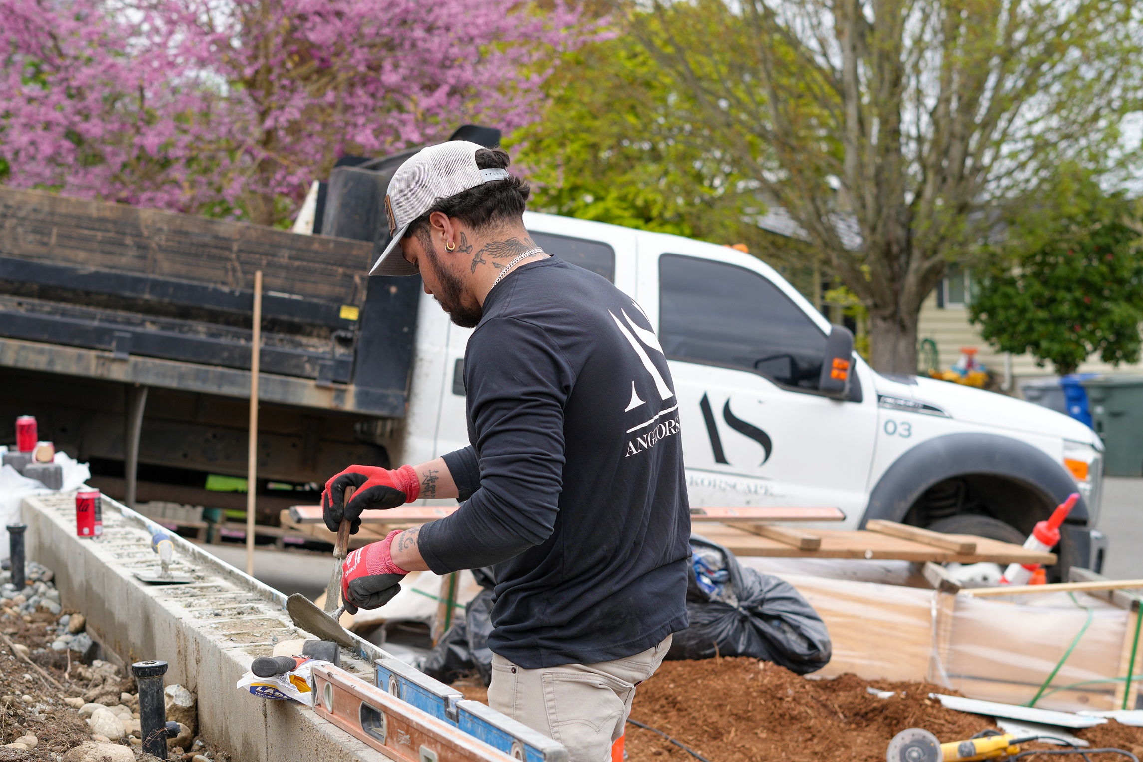 Hardscaping contractor applying cement for a retaining wall in Seattle