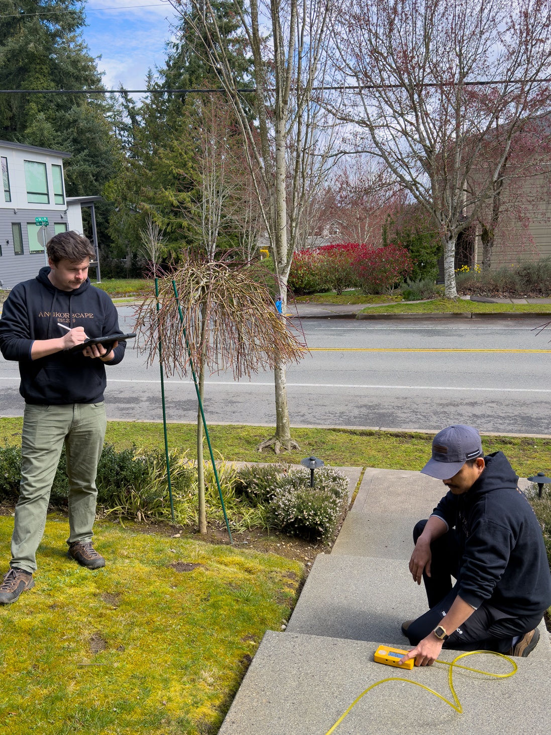Hardscaping contractors doing site survey in a Seattle frontyard