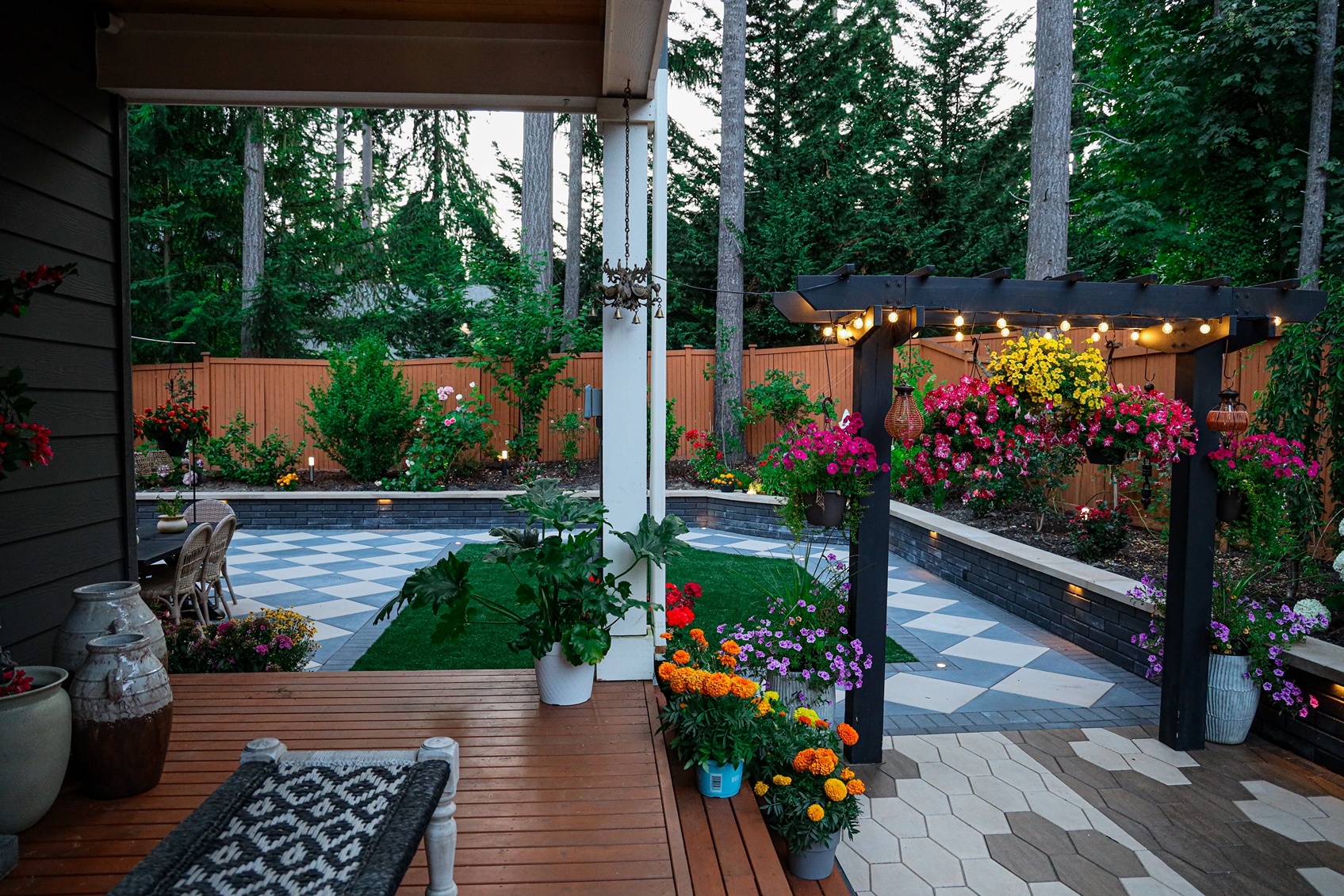 Remodeled backyard in Seattle with wide variety of potted and hanging plants