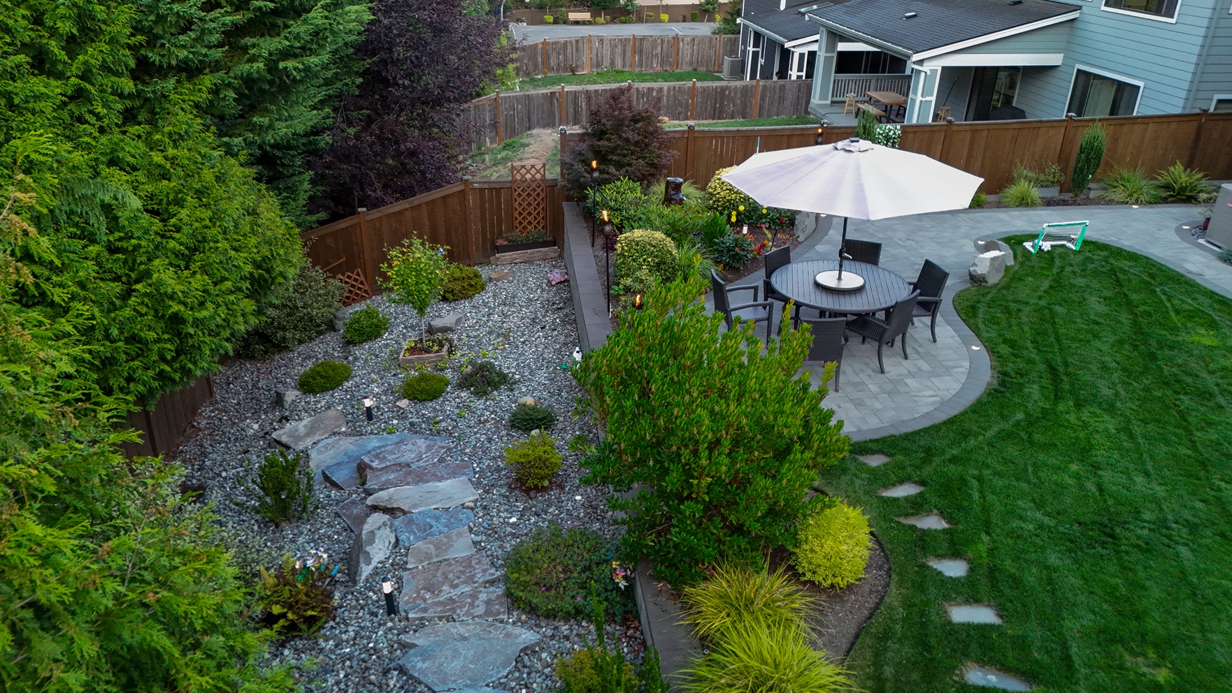 Backyard landscape project in Seattle with shrubs and custom pathways