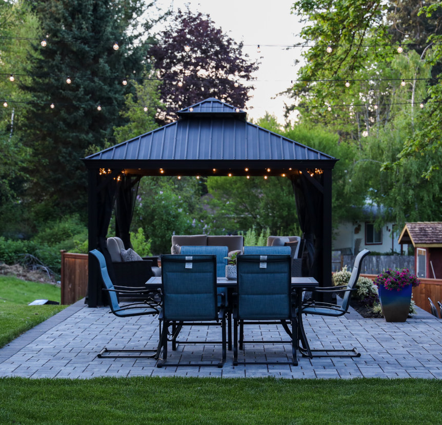 A finished landscaping project with newly installed gazebo and chairs