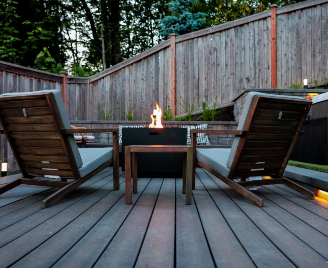 Backyard decking in Seattle with fire pit and wooden lounge chairs
