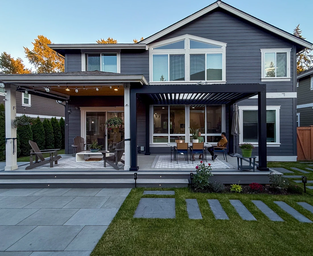 Covered patio in Seattle with wooden lounge chairs and artificial turf