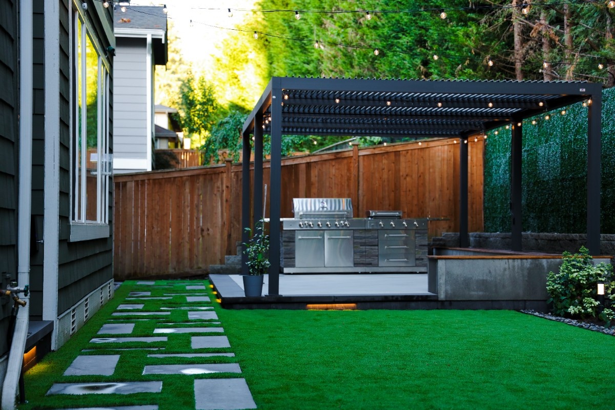 An outdoor kitchen installed in a roofed patio of a Seattle backyard