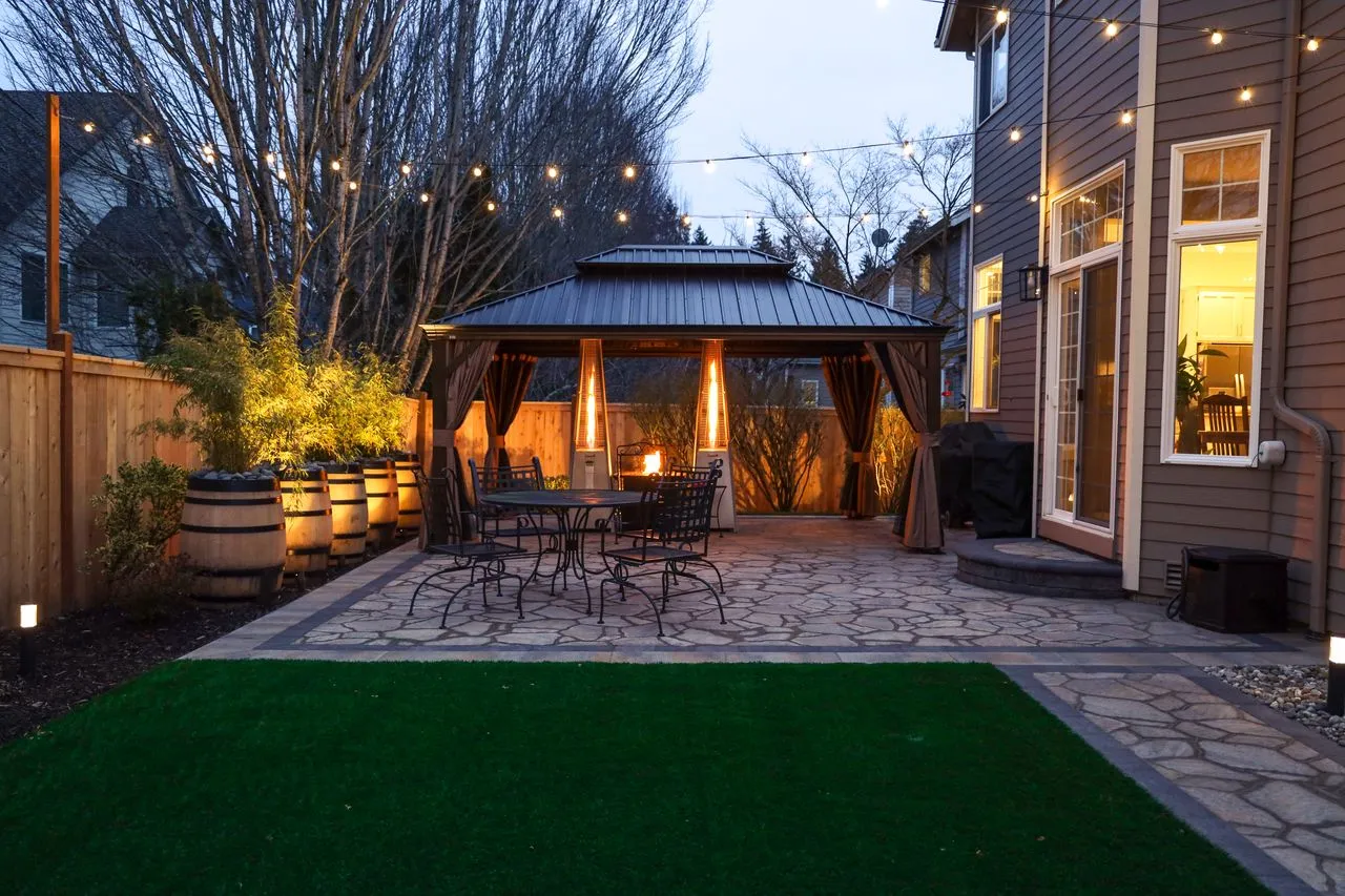 An installed patio with curtains and custom lighting