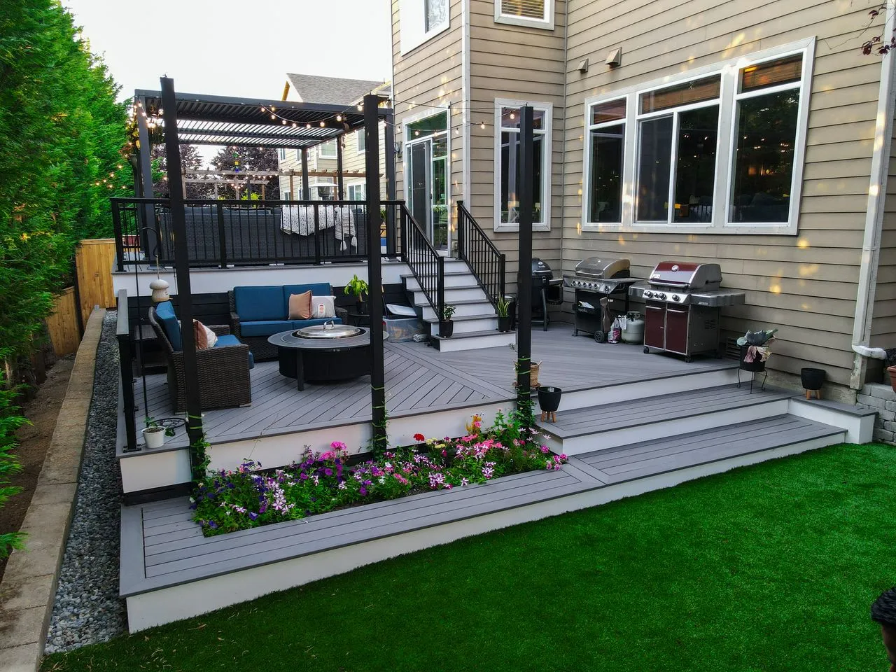 A multi-level wooden deck patio in Auburn with lounge area and fire pit