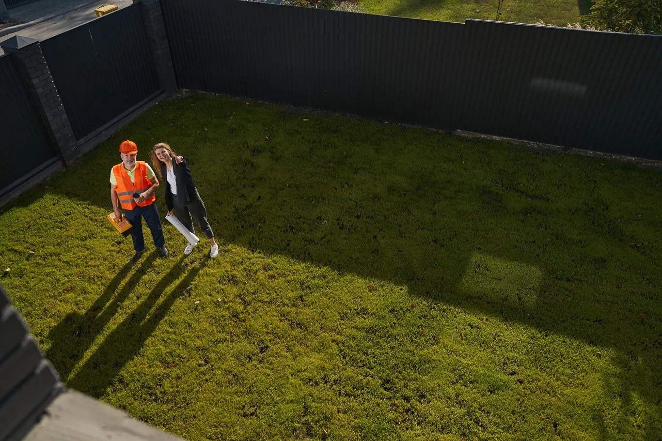 Landscape designer evaluating a Seattle lawn with homeowner.