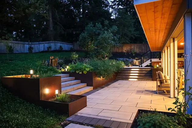 Evening patio with stone steps and corten planters.