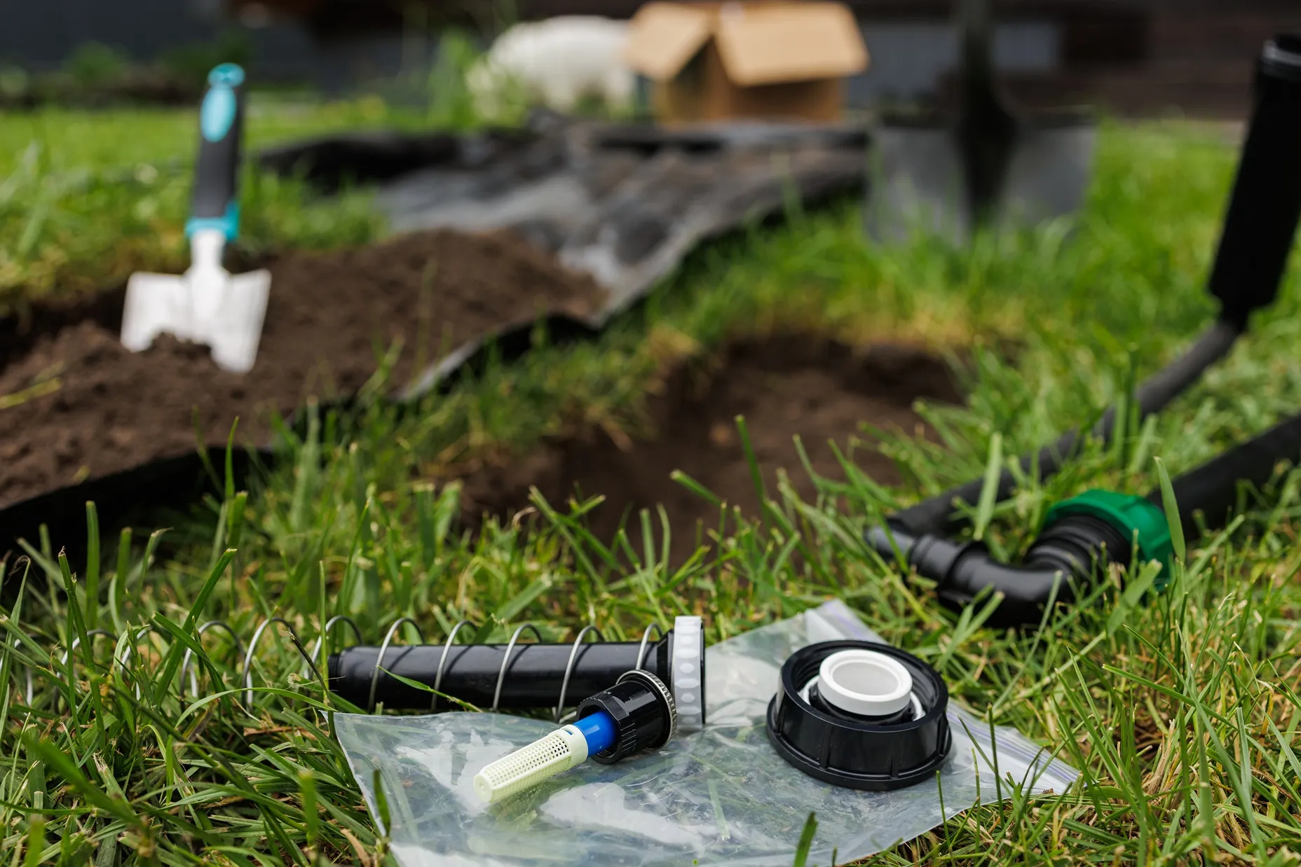 Irrigation system being installed in green lawn.