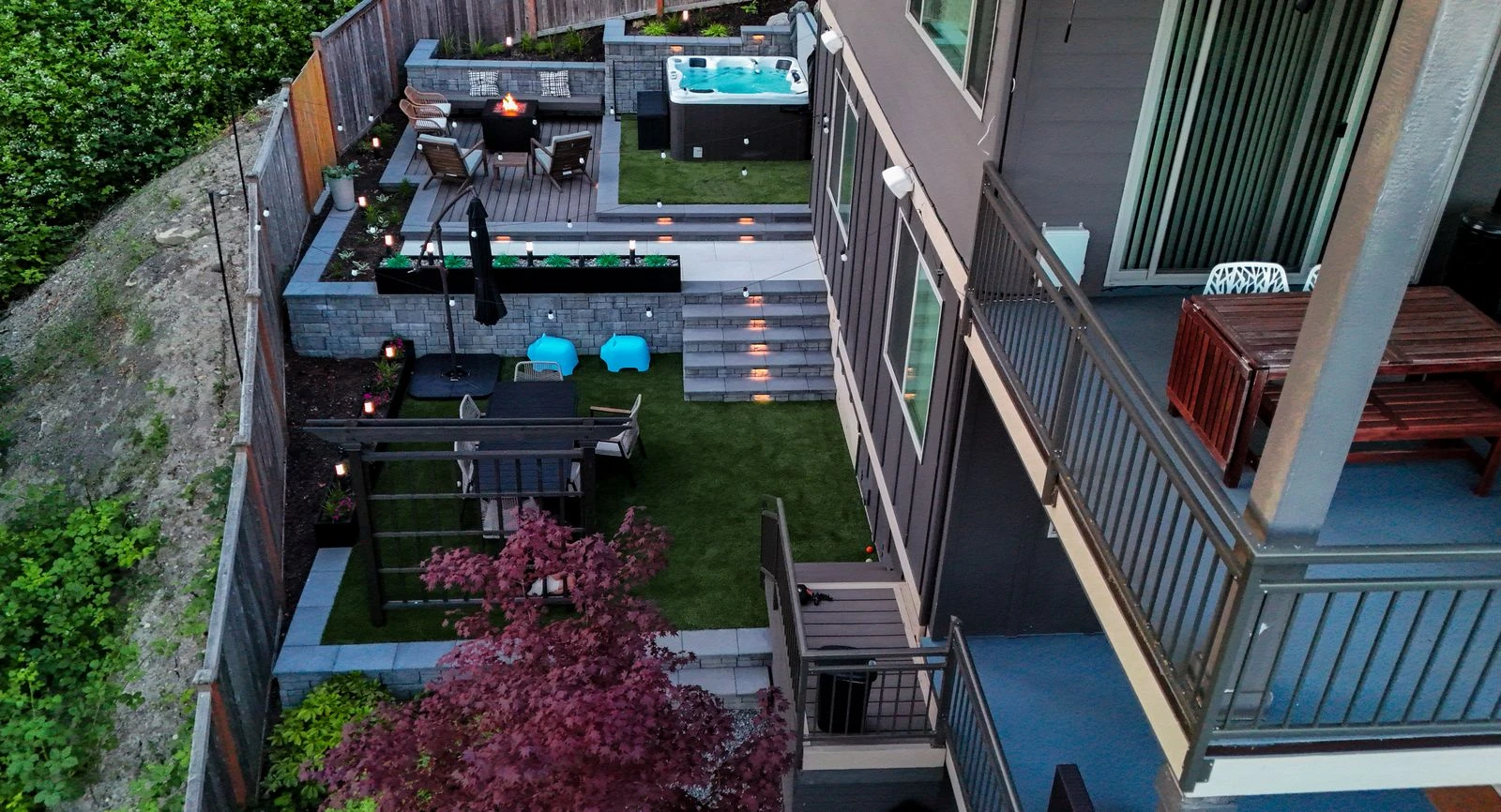 Overhead view of a multi-level terraced backyard landscape design with retaining walls