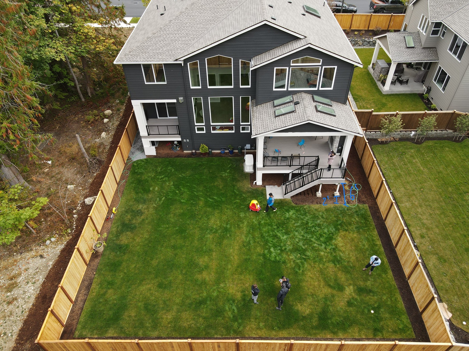 Backyard remodel contractors surveying a backyard before project starts in Redmond