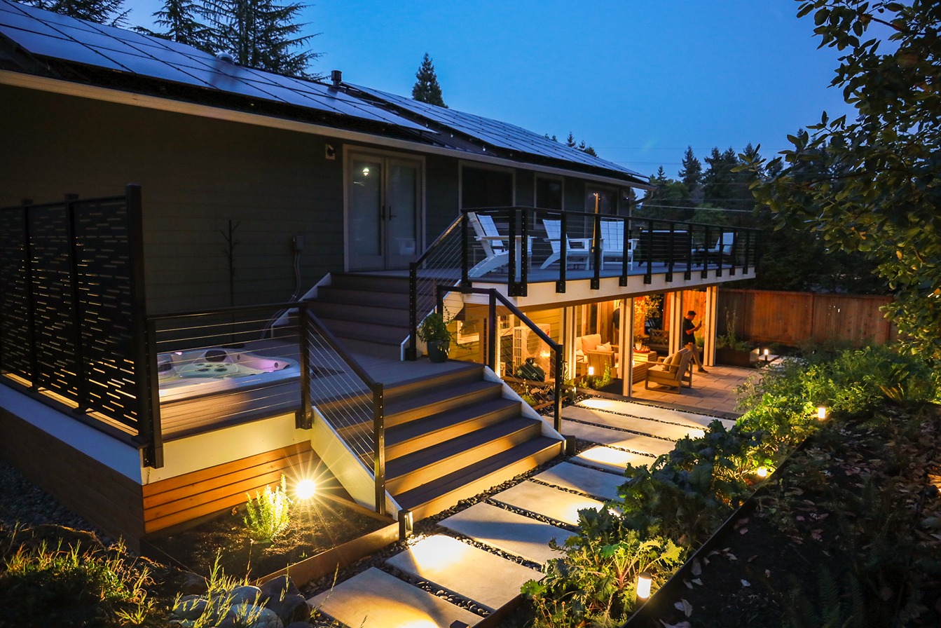 Remodeled patio in Bellevue at night with custom lighting on walkways