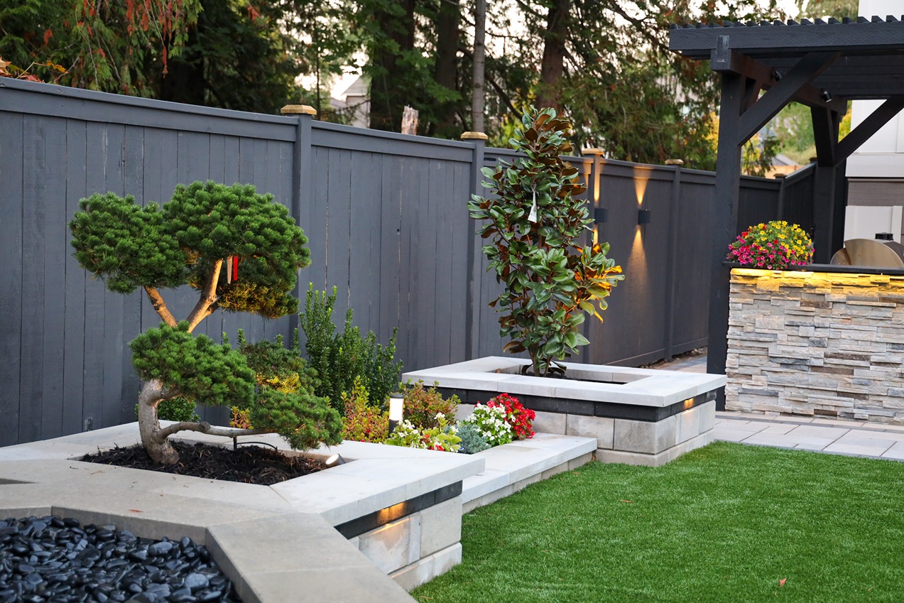 Plant boxes and fence with custom lighting in a Bellevue backyard