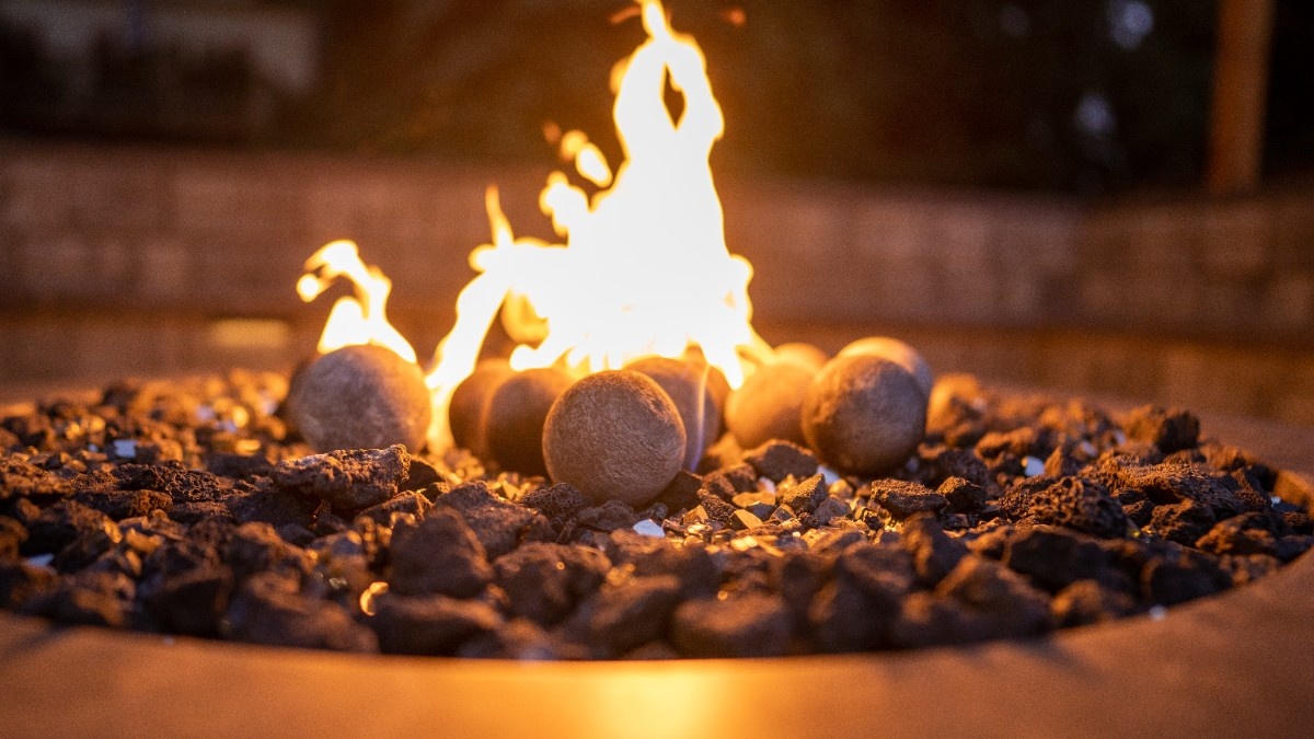Close-up of flames burning in a custom stone fire pit